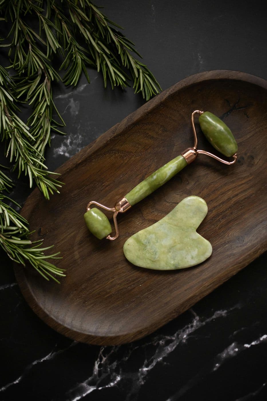 A jade stone and a small stack of handwritten cards on a linen cloth